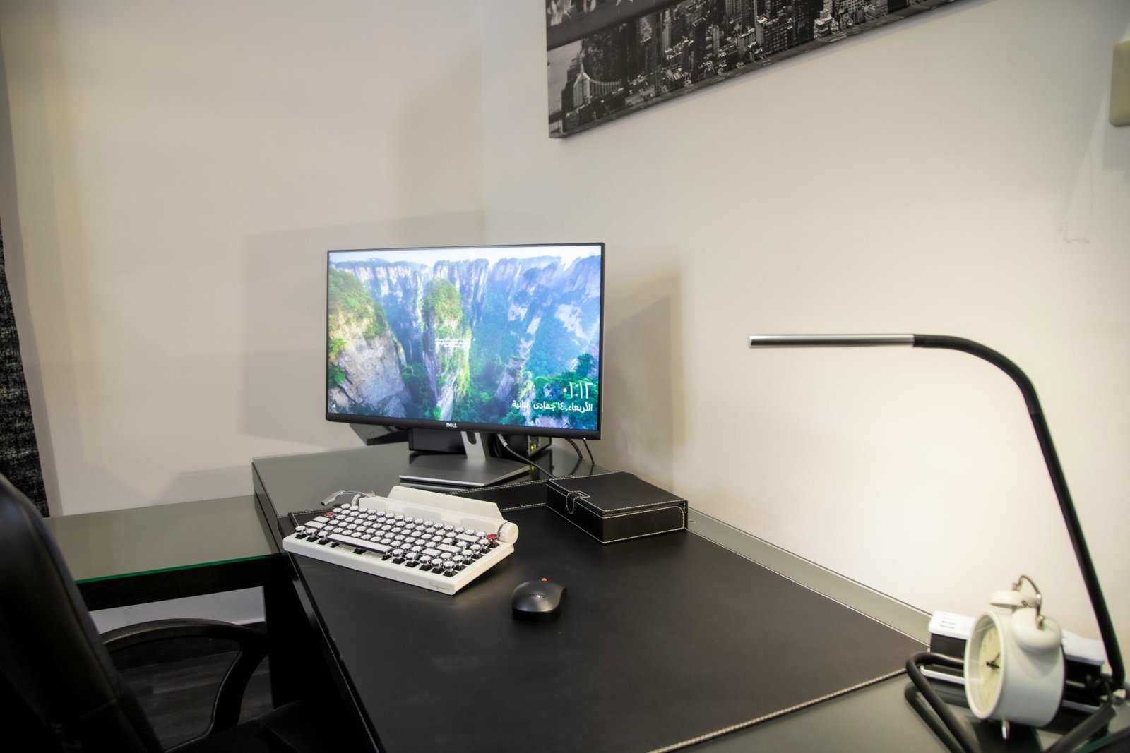 black flat screen computer monitor on black wooden desk